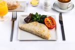 Egg white omelette with fresh herbs: a French-style egg white omelette with chives and basil, sided with kale, Portobello mushrooms and grilled roma tomato. Superfood to kick start your day.